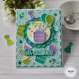 Handmade greeting card with balloons and presents with let's celebrate sentiment on it with crafting supplies in background. Handmade greeting card with balloons and presents with let's celebrate sentiment on it with crafting supplies in background.