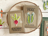 Two handmade gift card holders, one with a radish on it with sunshine seed co and ones with peas on it and just add sunshine sentiment on it.