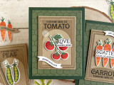 Handmade greeting card with tomatoes on it and love grows here sentiment on it and grown with love sentiment on it with crafting materials in background.