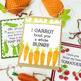 Handmade greeting card with carrots on it and I carrot 'bout you a whole bunch sentiment on it with crafting materials and cards in the background.