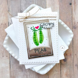 Handmade greeting card with two peas on it with peas label and grown with love sentiment on it with cardstock in background.