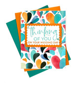 Handmade greeting card with foiled hearts on it and thinking of you on your wedding day sentiment with cardstock in background.