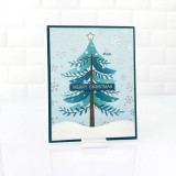 Handmade greeting card with tree on it with ornaments and snow with merry christmas sentiment on it.