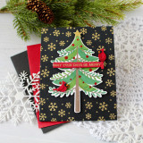 Handmade greeting card with tree on it with ornaments and two cardinal birds with may your days be merry sentiment on it.