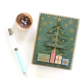 Handmade greeting card with tree on it with ornaments and presents underneath it and tis the season sentiment on it.