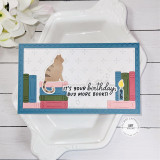 Handmade greeting card with books on it, a cat, and candle with it's your birthday, buy more books sentiment on it.