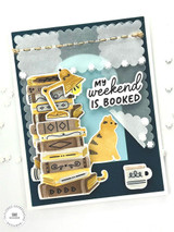 Handmade greeting card with books, a cat, lamp, and a mug on it with my weekend is booked sentiment on it.