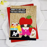 Handmade greeting card of Gnome in teacher's outfit with a pencil and apple and cheers to a new year, you make a difference sentiment on it.