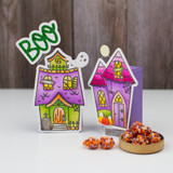 Two handmade greeting tags that are of different haunted houses and the sentiment boo on one of them with a ghost.