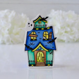 Handmade greeting tag of a haunted house with a ghost on it.