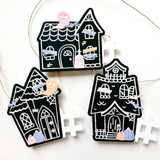 Three handmade greeting tags that are of different haunted houses.