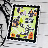 Handmade greeting card with haunted house, monsters, and pumpkins on it with haunted hello sentiment on it.