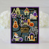 Handmade greeting card with haunted house, monsters and pumpkins on it with haunted hello sentiment on it.