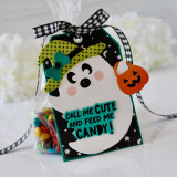 Handmade gift tag with a ghost on it holding a pumpkin and call me cute and feed me candy sentiment on it.