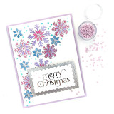 Handmade greeting card with snowflakes on it and merry christmas sentiment on it.