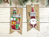 Two handmade greeting tags, one with a sled of presents on it and the other with santa on it.