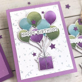 Handmade greeting card with balloons holding a present up with stars in the background and celebrating you sentiment on it. Handmade greeting card with balloons holding a present up with stars in the background and celebrating you sentiment on it.