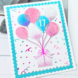 Handmade greeting card with balloons holding a present up with 17 on one of the balloons.