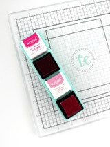 Image of Glassboard Buddy - Mini Ink Cubes which is a magnetic tray that holds mini ink pads and in the picture there is an example of two mini inks with the lids off. Image of Glassboard Buddy - Mini Ink Cubes which is a magnetic tray that holds mini ink pads and in the picture there is an example of two mini inks with the lids off.