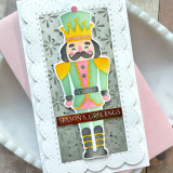 Handmade greeting card with a nut cracker on it and season's greetings sentiment on it.