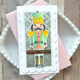 Handmade greeting card with a nutcracker on it and season's greetings sentiment on it.