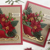 Two handmade greeting cards with sleighs and flowers on each with two different holiday greetings on both.