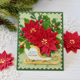 Handmade greeting card with flowers in a sleigh and merry Christmas sentiment on it.