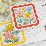 Two handmade calendars with flowers on both.