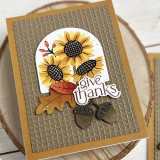 Handmade greeting card with sunflowers on it and leaves with give thanks sentiment on it.