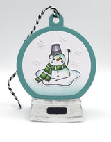 Handmade greeting tag with melting snowman on it.