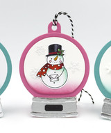 Handmade greeting tag with a snowman on it holding an envelope.