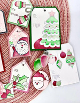 Up close image of a lot of handmade greeting tags with santa, snowmen, christmas trees, and ornaments on each of them.