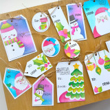 A lot of handmade greeting tags with santa, snowmen, christmas trees, and ornaments on each of them. A lot of handmade greeting tags with santa, snowmen, christmas trees, and ornaments on each of them.