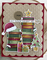 Handmade greeting card with books and santa hat on it with let your heart e light sentiment on it.