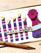 Handmade greeting card with candles on it and a party hat with make a wish sentiment on it.