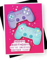 Handmade greeting card with two gaming controllers on it and happy birthday! you've unlocked another year sentiment on it.