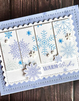 Handmade greeting card with snowflakes on it and warm wishes sentiment on it.
