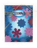 Handmade greeting card with snowflakes on it and warm wishes sentiment on it.