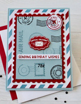Handmade greeting card with postage stamps on it and sending birthday wishes sentiment on it.