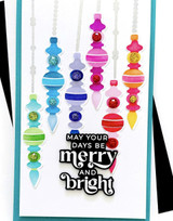 Handmade greeting card with ornaments on it with merry and bright sentiment on it.