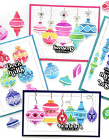 Four handmade greeting cards with ornaments on each and various holiday sentiments on each of them.