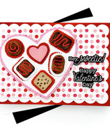 Handmade greeting card with chocolate hearts inside a heart on it with hey sweetie sentiment on it and happy valentine's day sentiment on it.