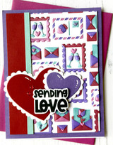 Handmade greeting card with envelopes and hearts on it and sending love sentiment on it.