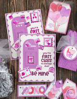 Two handmade greeting cards with mail box on it and you're first class no postage due sentiment on it with heart shaped envelopes on it and be mine sentiment on both, with gift tags surrounding cards.