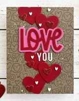 Handmade greeting card with hearts on it and love you sentiment on it.