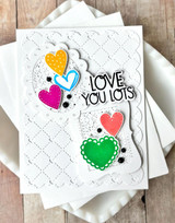 Handmade greeting card with hearts on it and love you lots sentiment on it.
