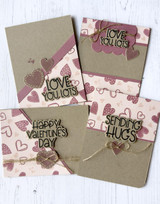 Four handmade greeting cards with different valentine's day sentiments on each of them.