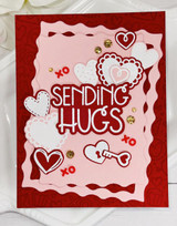 Handmade greeting card with keys and hearts on it with sending hugs sentiment on it.