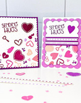 Two handmade greeting cards with hearts and keys on each and sending hugs sentiment on each.