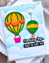 Handmade greeting card with two hot air balloons on it and floating by just to say hi sentiment on it.